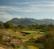 The par-3 eighth hole at Grayhawk Golf Club's Raptor course, named Aces and Eights, is short but heavily guarded with bunkers. 