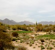 The fifth hole on the Cholla course at We-Ko-Pa Golf Club is a long par 3 over desert. 