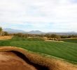 The seventh hole on the Cholla course at We-Ko-Pa Golf Club is a short par 4 with a split fairway leading up to an elevated green. 